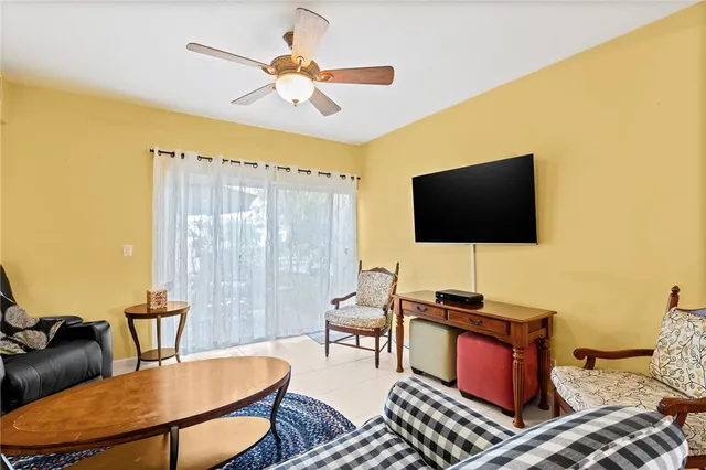 a view of a livingroom with a chandelier furniture and windows