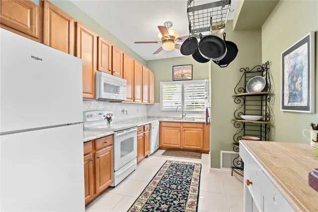 a kitchen with stainless steel appliances granite countertop a sink a stove microwave and cabinets