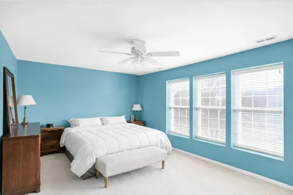 a bedroom with a large bed and a large window