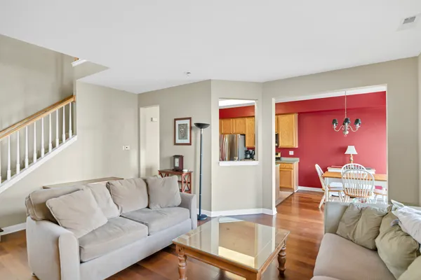 a living room with furniture a flat screen tv and a large window