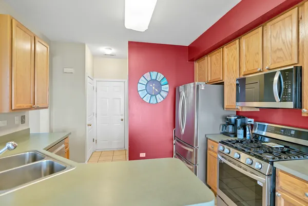 a kitchen with stainless steel appliances granite countertop a refrigerator stove and sink