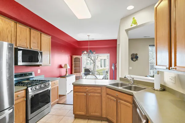 a kitchen with stainless steel appliances a sink stove and cabinets