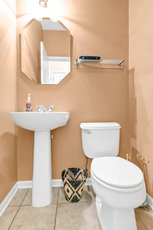 a white toilet sitting next to a bathroom sink