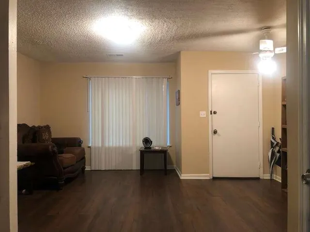 a view of hallway with couch and a workspace