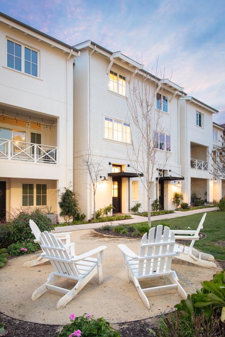 a building view with couches and a table and chairs in patio
