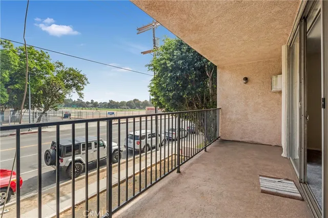 a view of kitchen with granite countertop white cabinets and sink