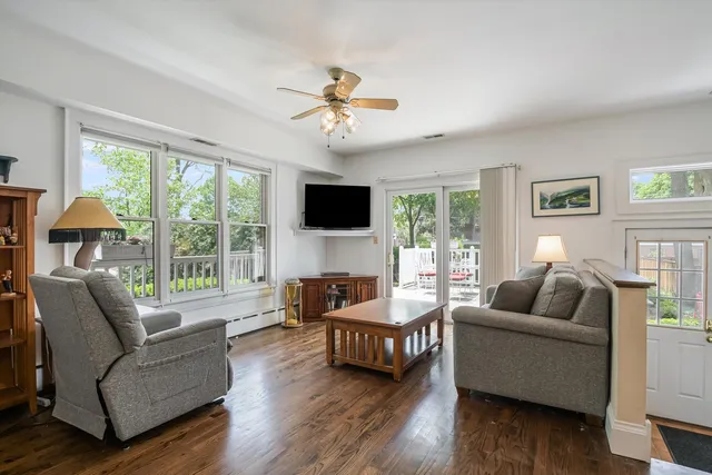 a living room with furniture and kitchen view