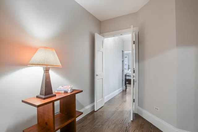 a large bedroom with a bed and a dresser in it