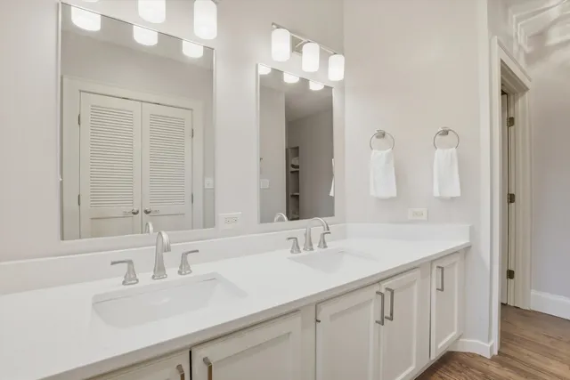 a view of a hallway with closet and wooden floor