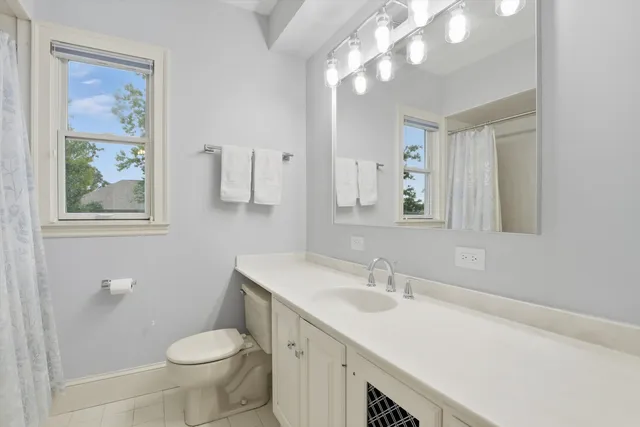 a view of a patio with table and chairs and wooden fence