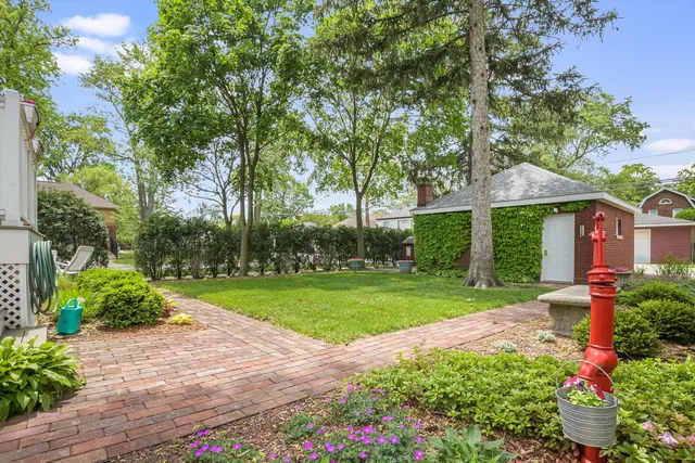 an aerial view of residential house with outdoor space and trees all around