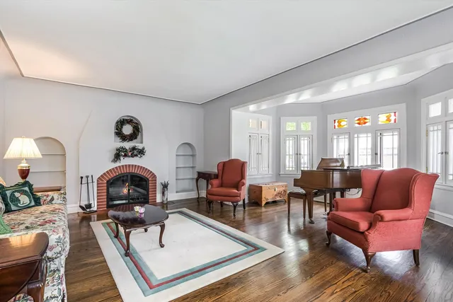 a living room with furniture and floor to ceiling windows