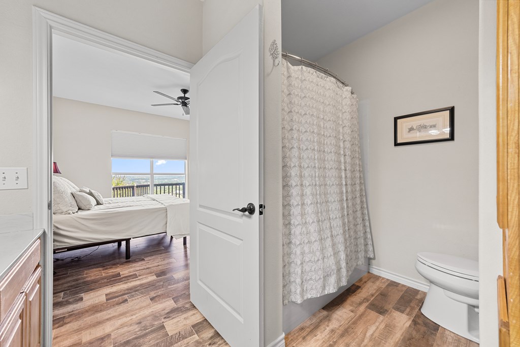 1008 Edinburgh Drive Kerrville, TX 78028 - Photo 20 of 25 a view of a bedroom with wooden floor and furniture