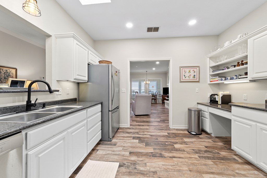 1008 Edinburgh Drive Kerrville, TX 78028 - Photo 5 of 25 a kitchen with stainless steel appliances granite countertop a sink stove and refrigerator