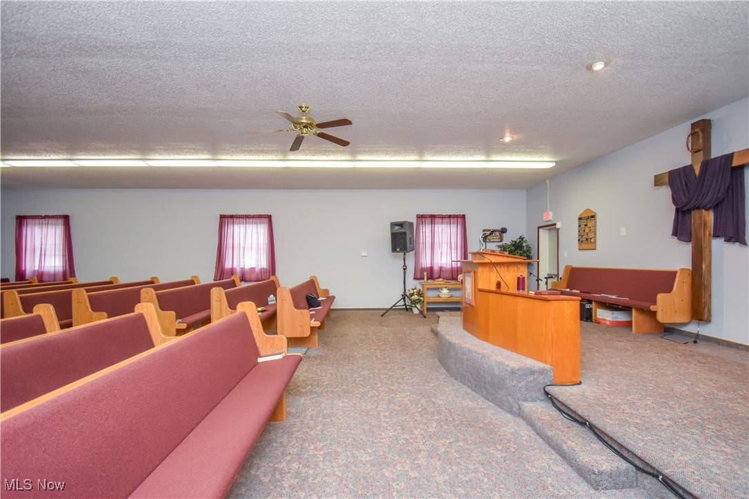 1187 Deforest Road Southeast Warren, OH 44484 - Photo 16 of 42 Miscellaneous room with carpet, ceiling fan, and a textured ceiling