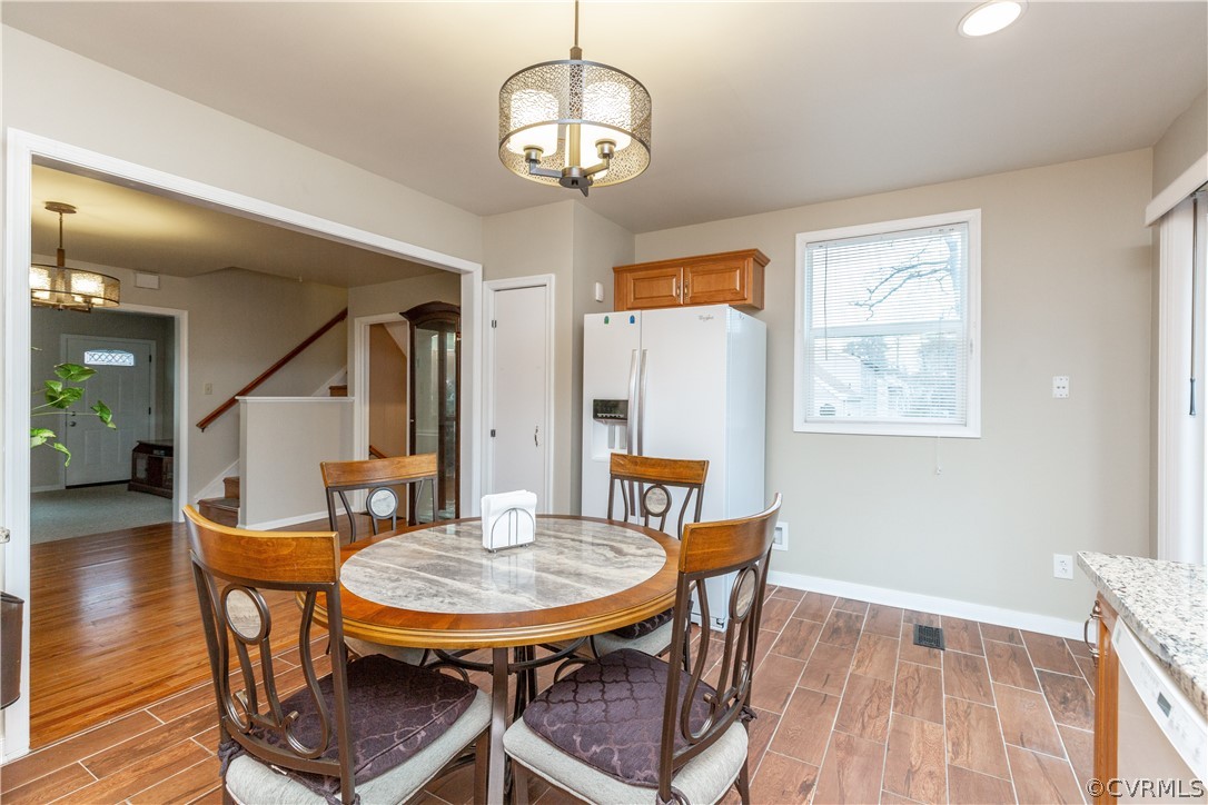 833 Adkins Road Chesterfield, VA 23236 - Photo 14 of 30 a view of a dining room with furniture and wooden floor