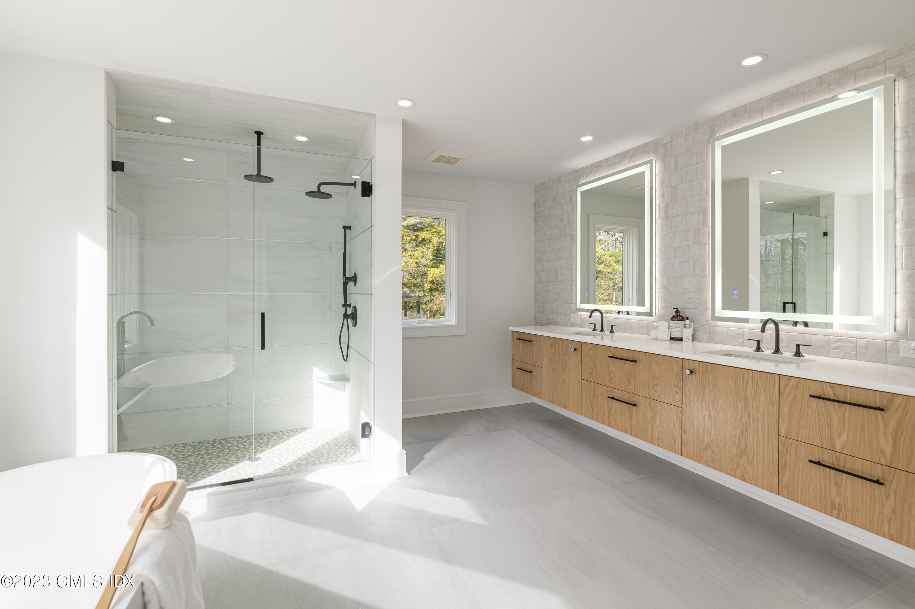 261 Cognewaugh Road Cos Cob, CT 06807 - Photo 19 of 38 a bathroom with a granite countertop tub sink and mirror