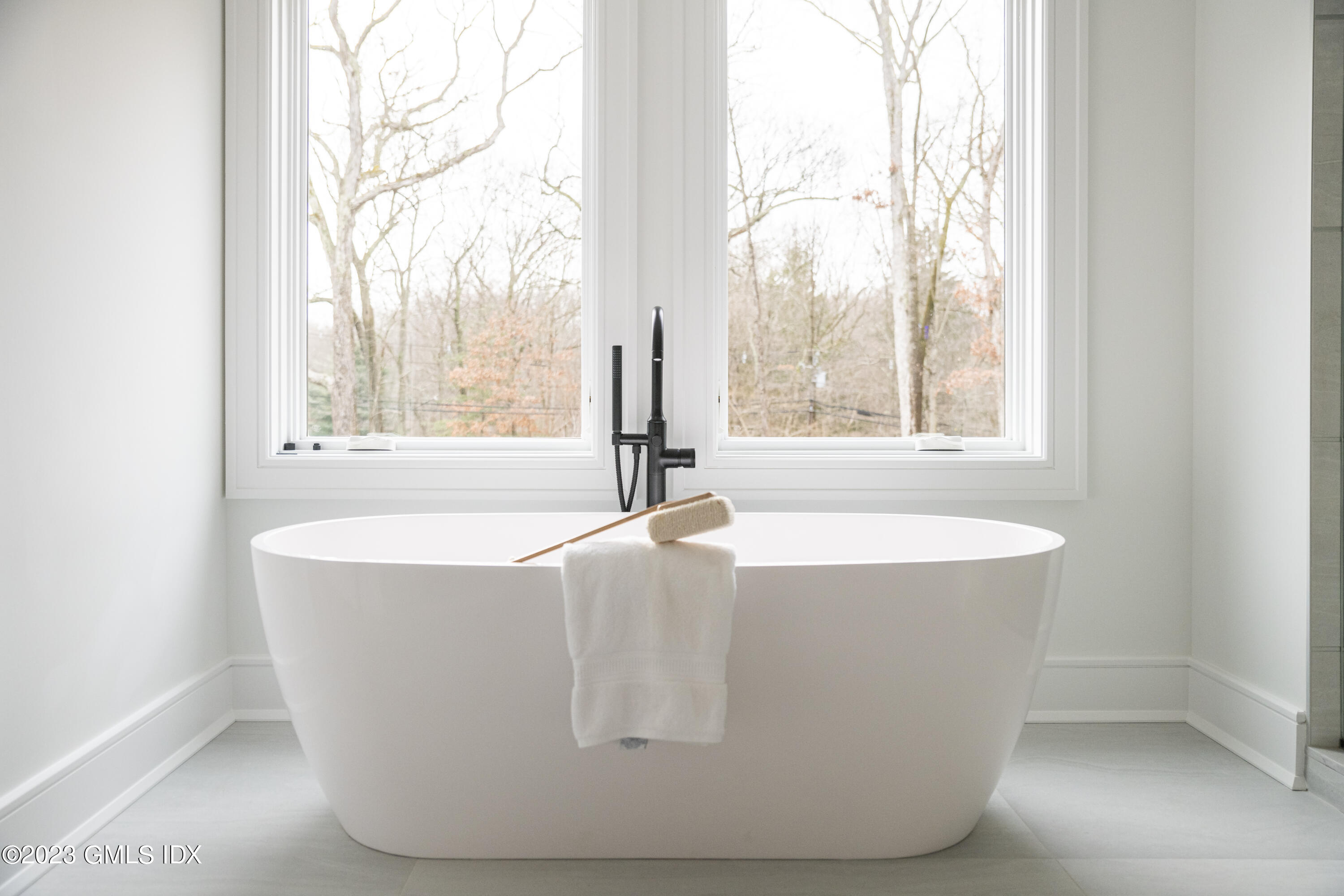 261 Cognewaugh Road Cos Cob, CT 06807 - Photo 21 of 38 a white bath tub sitting in a bathroom