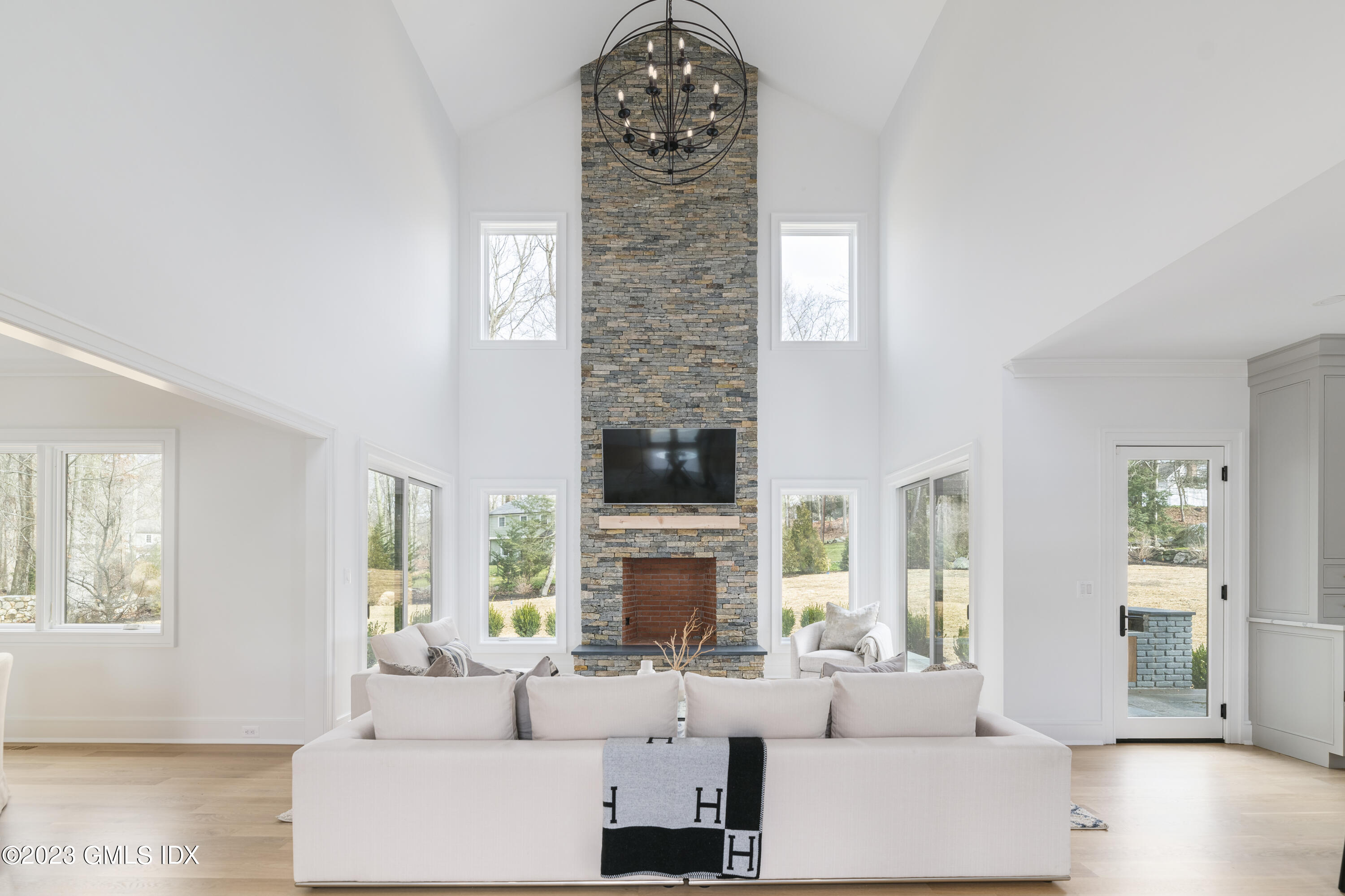 261 Cognewaugh Road Cos Cob, CT 06807 - Photo 3 of 38 a living room with fireplace a large window and a fireplace
