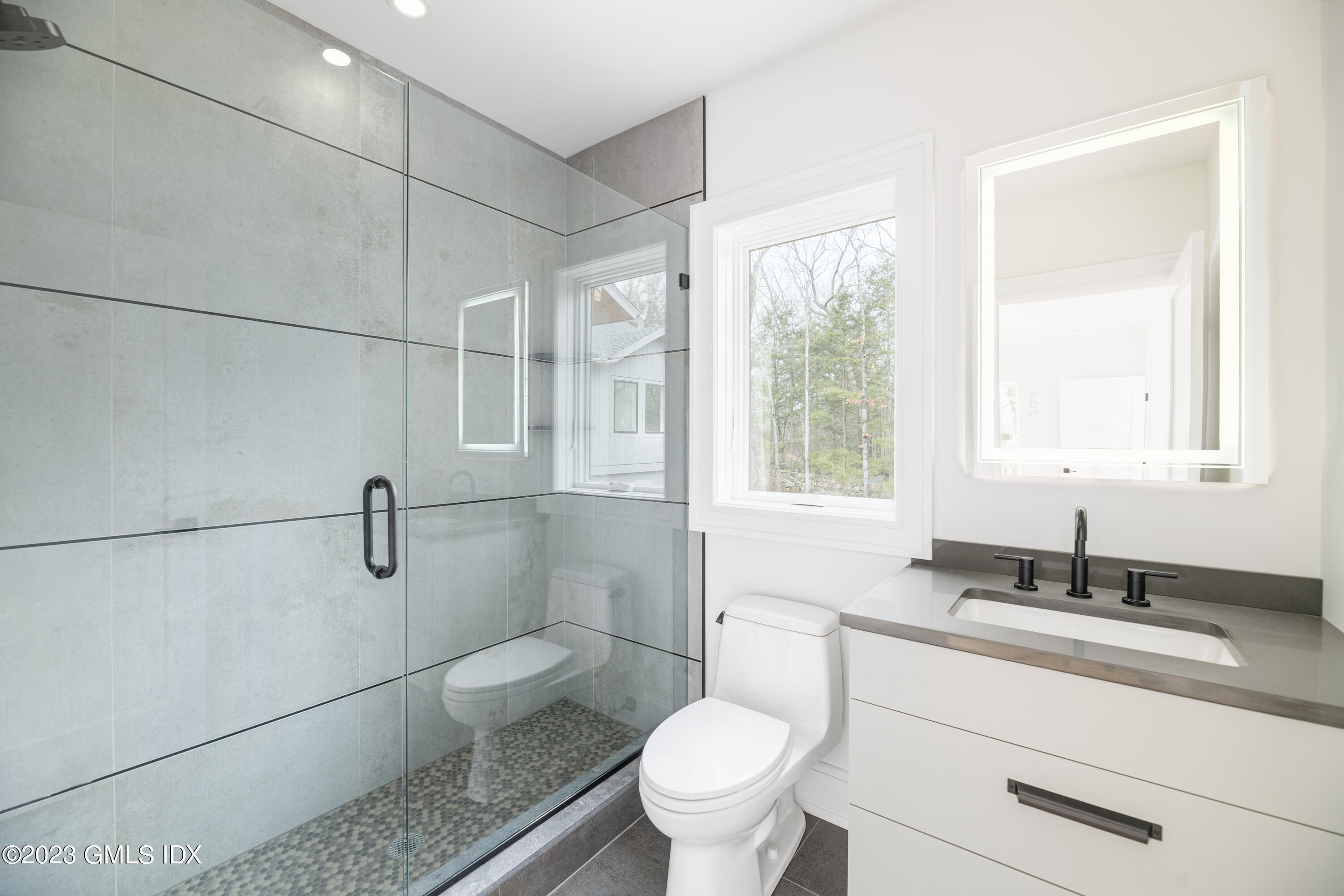 261 Cognewaugh Road Cos Cob, CT 06807 - Photo 31 of 38 a bathroom with a granite countertop sink a toilet and shower