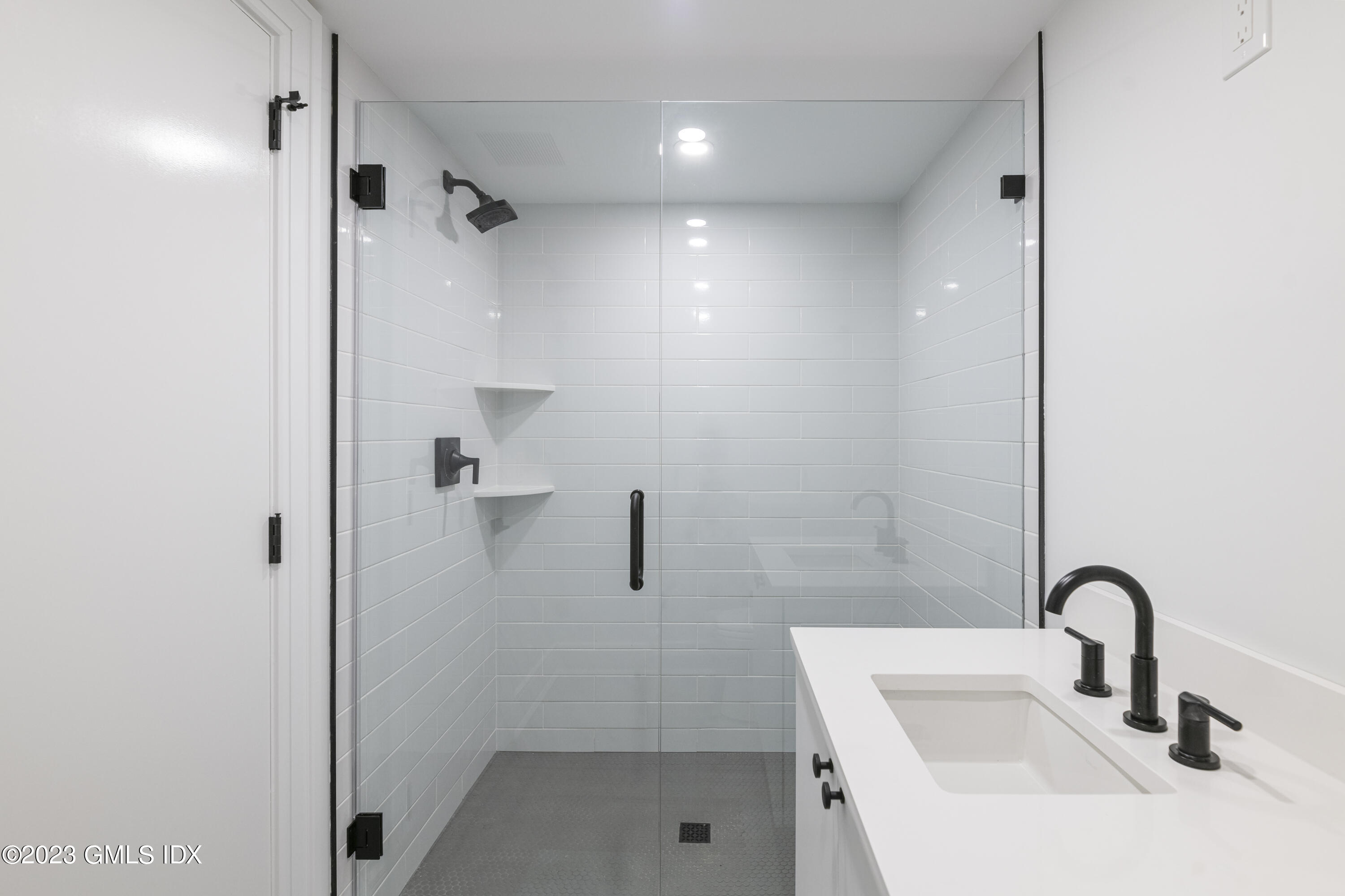 261 Cognewaugh Road Cos Cob, CT 06807 - Photo 33 of 38 a bathroom with a sink and shower