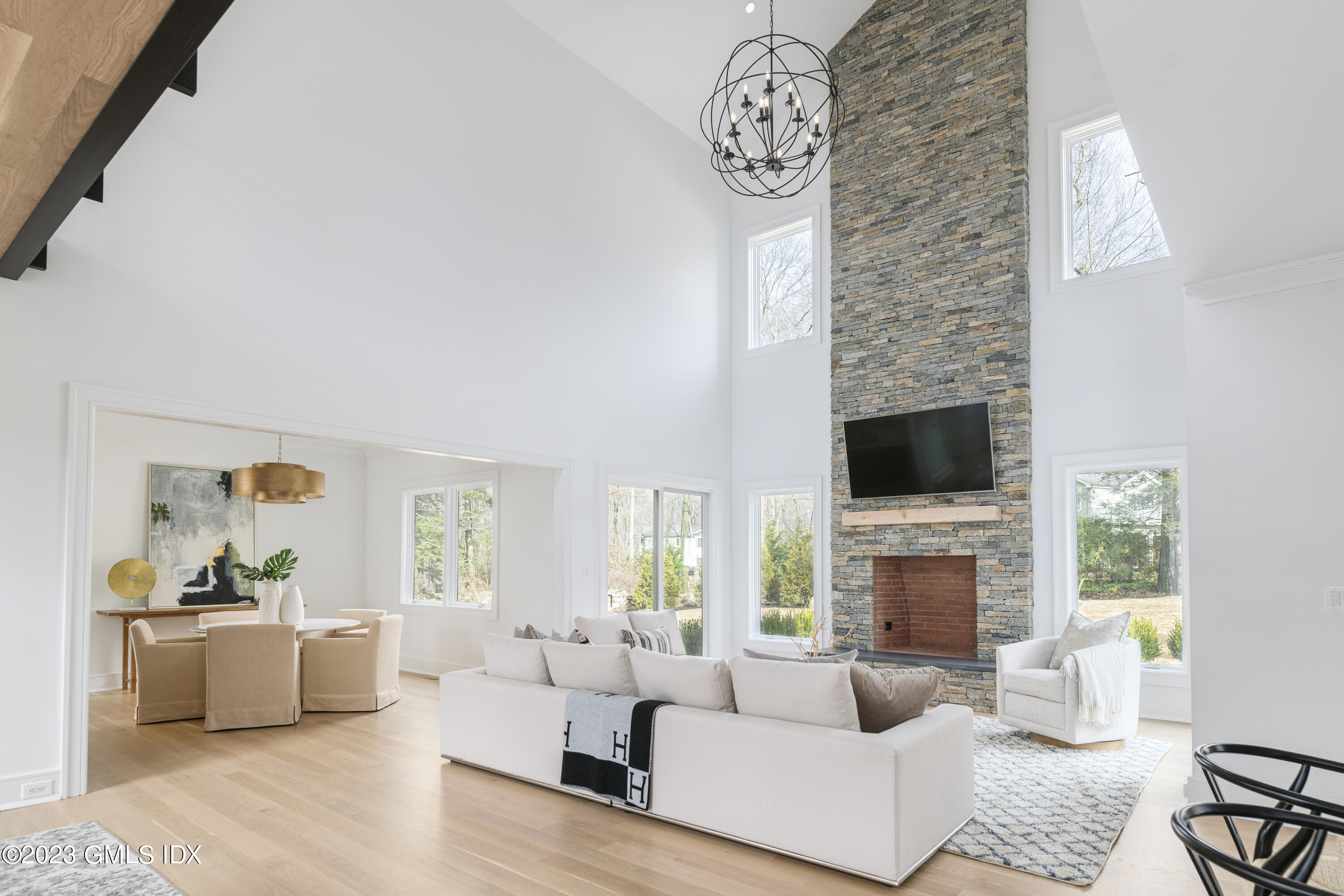 261 Cognewaugh Road Cos Cob, CT 06807 - Photo 4 of 38 a living room with furniture a fireplace and a flat screen tv