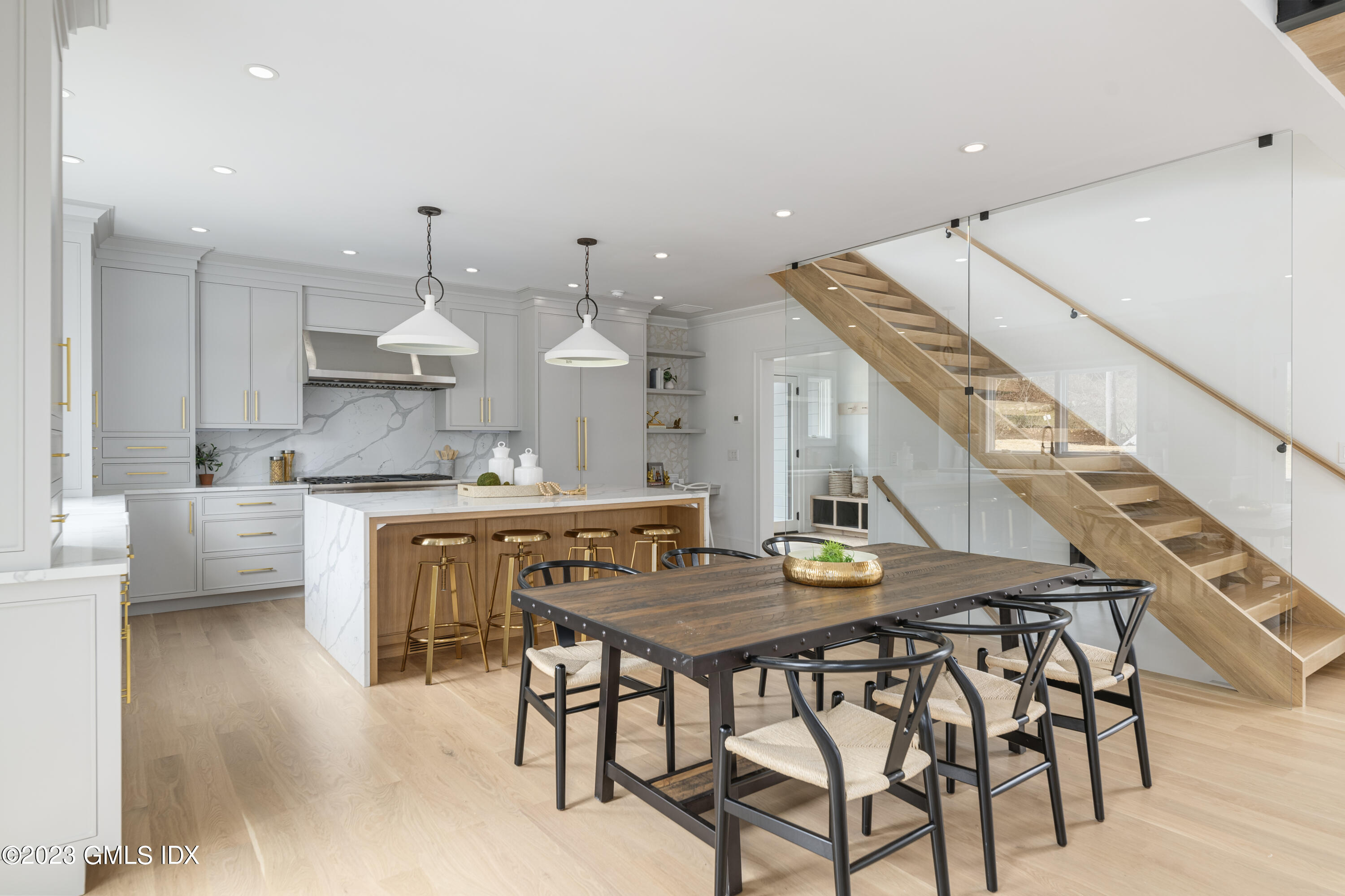 261 Cognewaugh Road Cos Cob, CT 06807 - Photo 9 of 38 a kitchen with a table chairs stove and cabinets