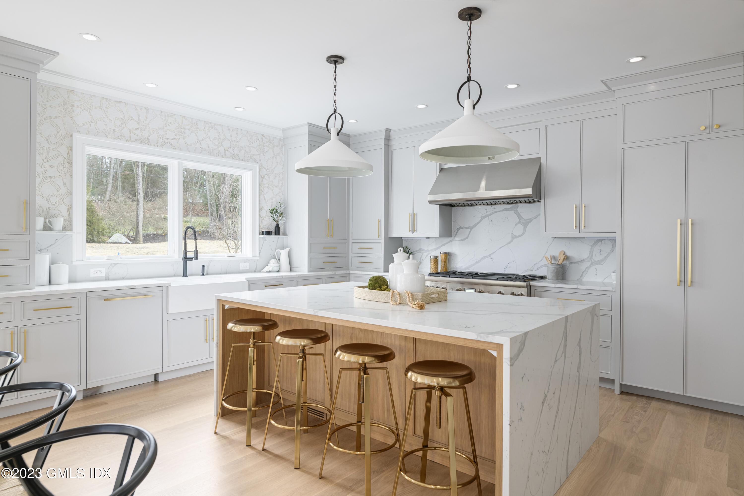 261 Cognewaugh Road Cos Cob, CT 06807 - Photo 10 of 38 a kitchen with stainless steel appliances granite countertop a sink a stove a refrigerator and island with wooden floor