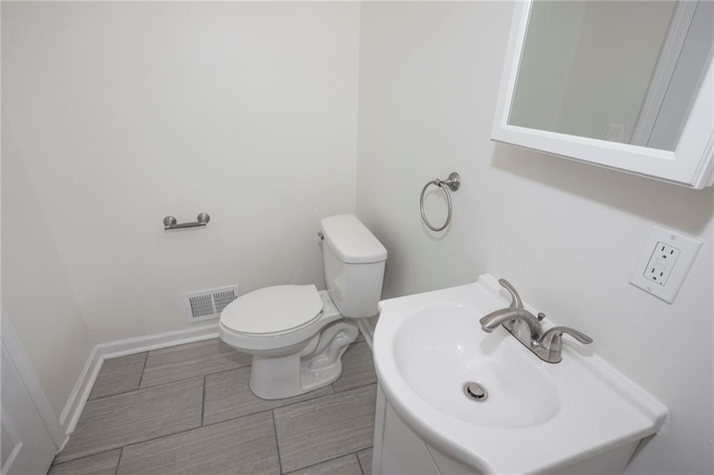 1101 2nd Avenue Coraopolis, PA 15108 - Photo 12 of 26 a bathroom with a sink a toilet and mirror
