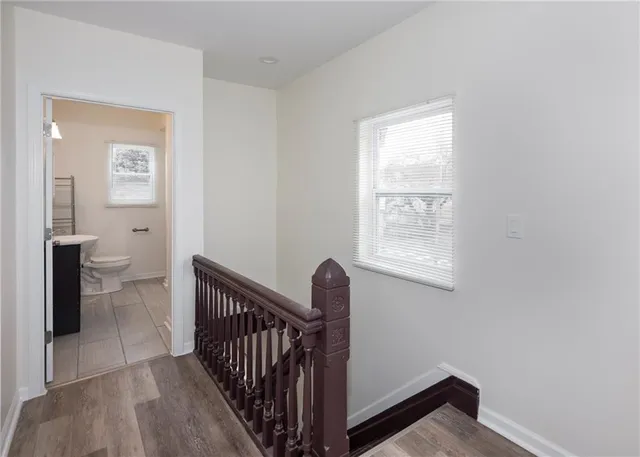 a view of a hallway with a toilet and a window