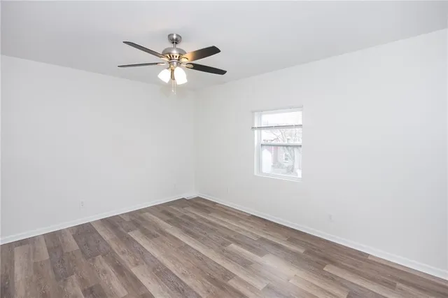 a view of a big room with wooden floor and windows in a room