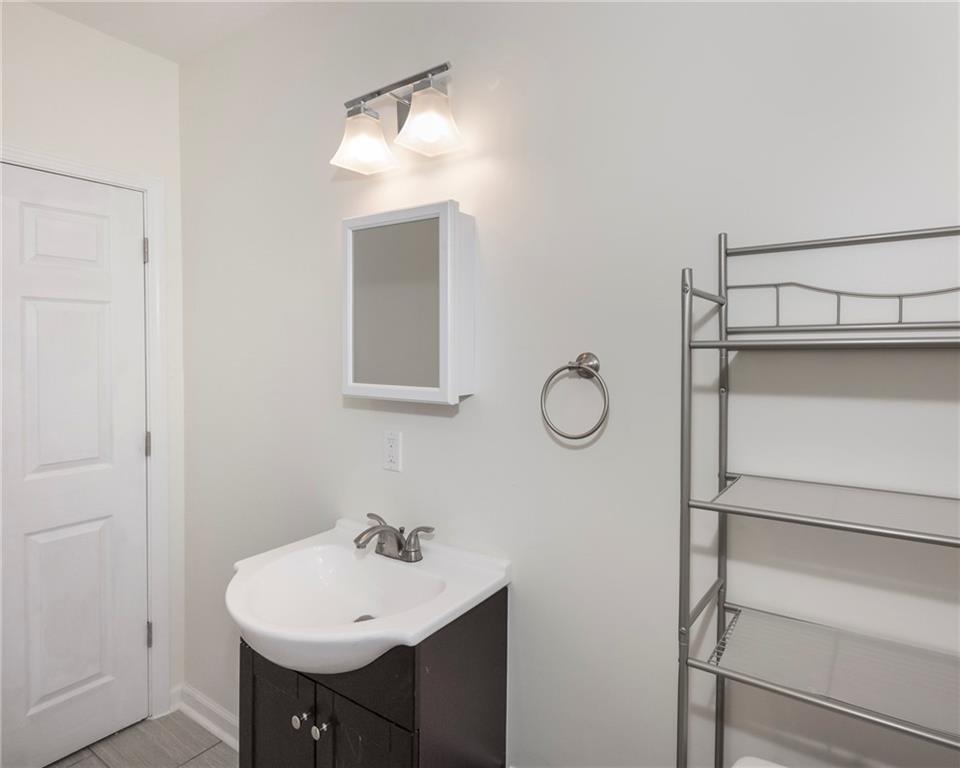 1101 2nd Avenue Coraopolis, PA 15108 - Photo 19 of 26 a bathroom with a sink and a mirror