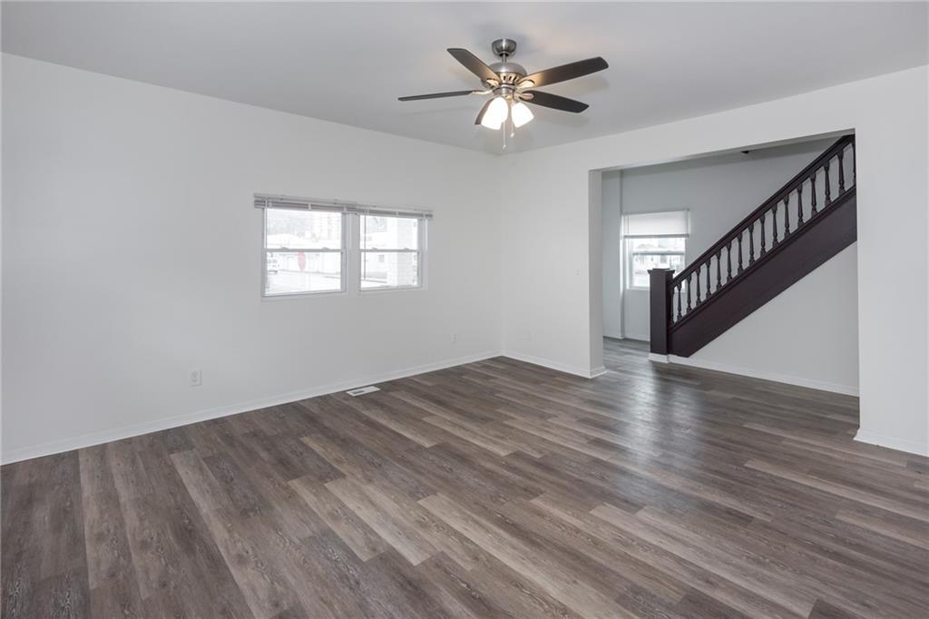 1101 2nd Avenue Coraopolis, PA 15108 - Photo 6 of 26 a view of an empty room with wooden floor and a window