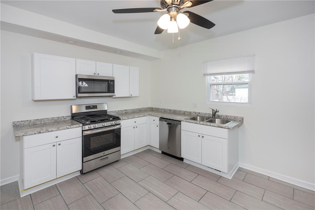 1101 2nd Avenue Coraopolis, PA 15108 - Photo 8 of 26 a kitchen with a sink stove and microwave