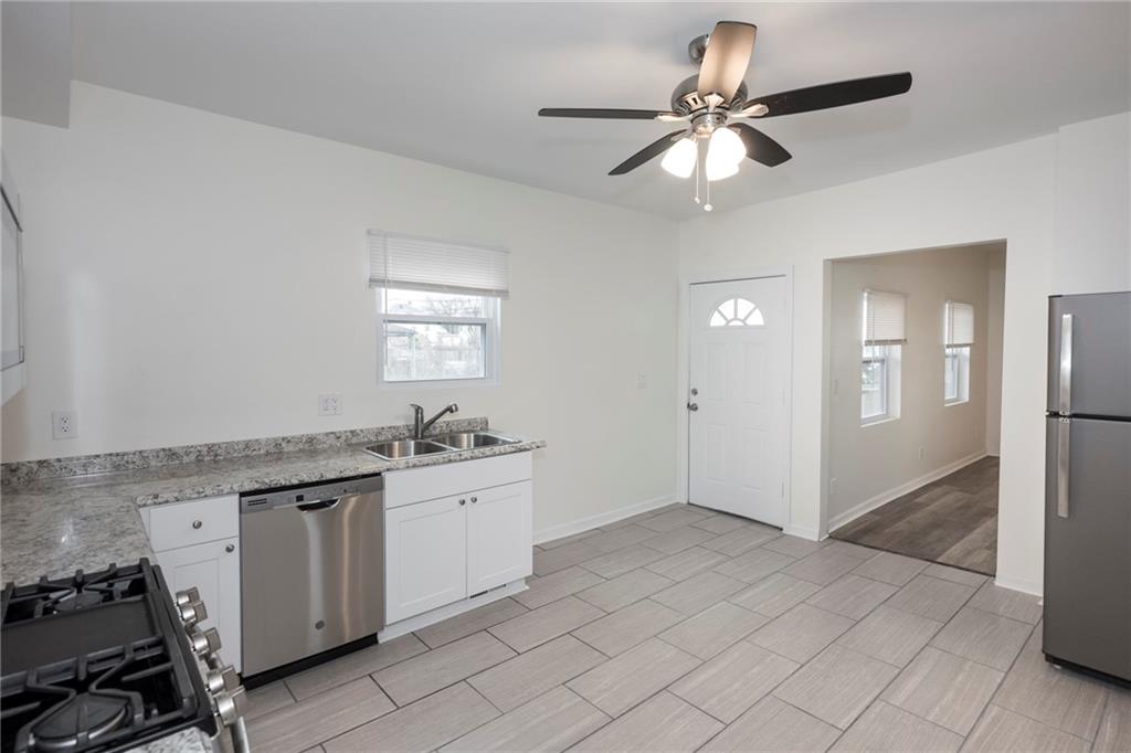 1101 2nd Avenue Coraopolis, PA 15108 - Photo 9 of 26 a kitchen with granite countertop a sink and a stove