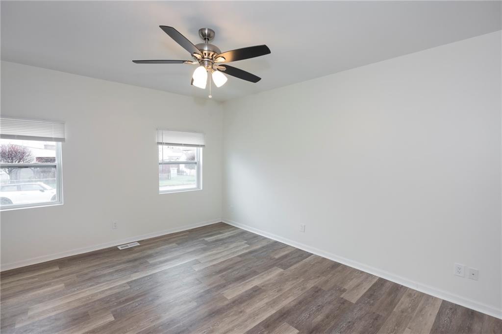 1101 2nd Avenue Coraopolis, PA 15108 - Photo 10 of 26 a view of an empty room with wooden floor and a window