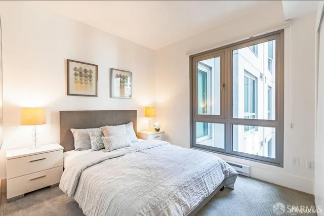 a bedroom with a bed and lamps