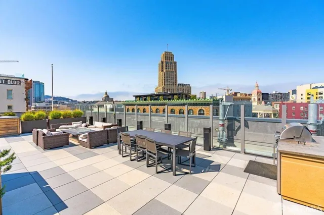 a view of swimming pool with outdoor seating and city view