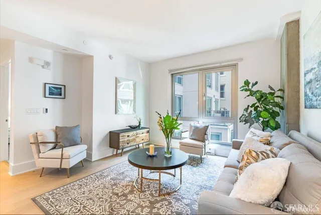 a living room with furniture and a potted plant on table