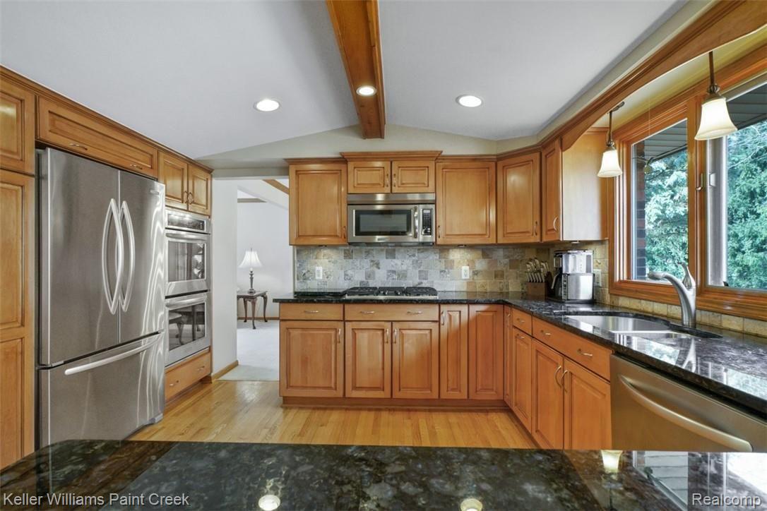 3098 Baypoint Drive Rochester, MI 48309 - Photo 10 of 32 Impressive updated Kitchen with granite counter tops, maple cabinetry, Stainless steel appliances (including a double oven) and back splash.