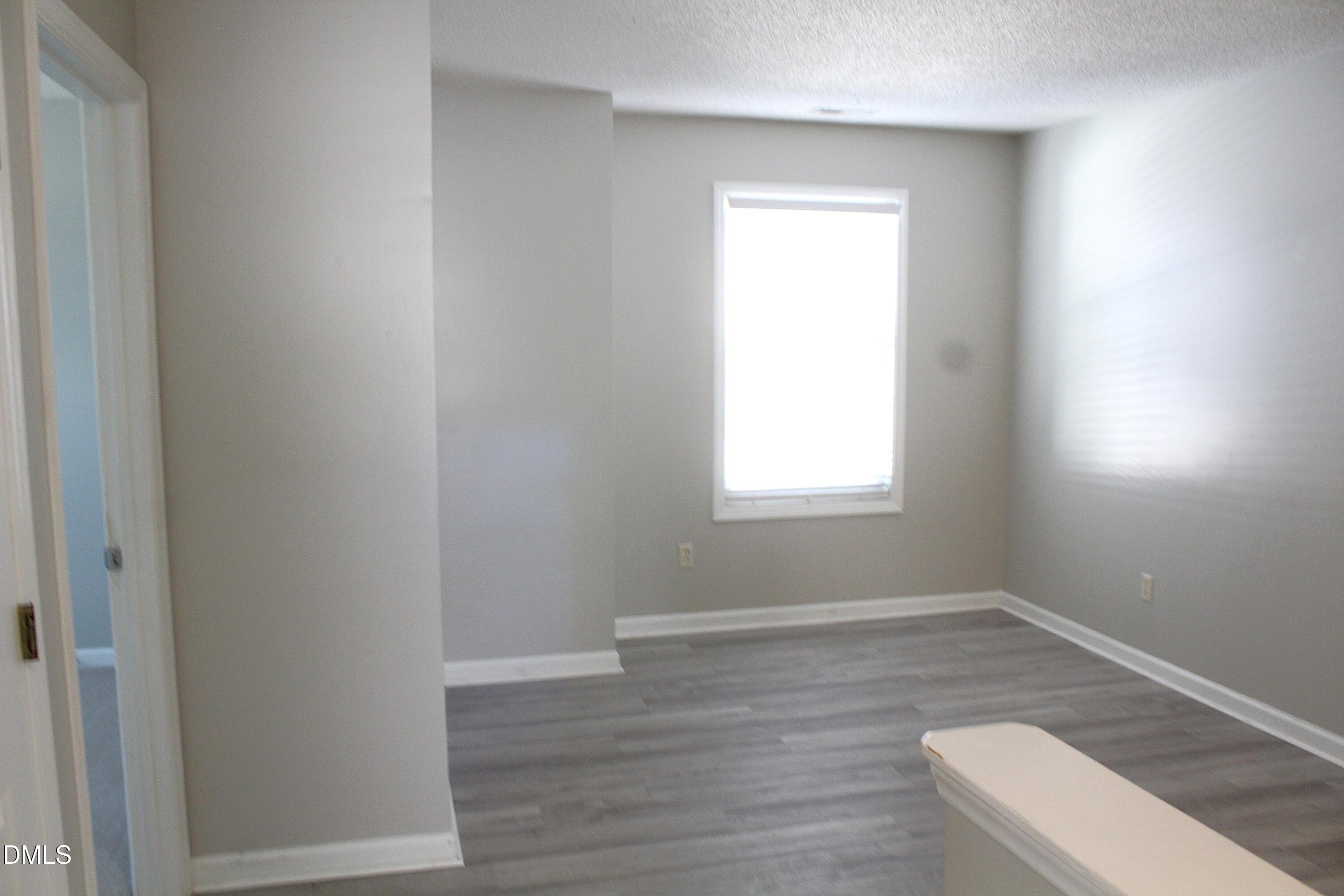 4305 Standing Rock Way Raleigh, NC 27604 - Photo 5 of 11 an empty room with wooden floor and windows