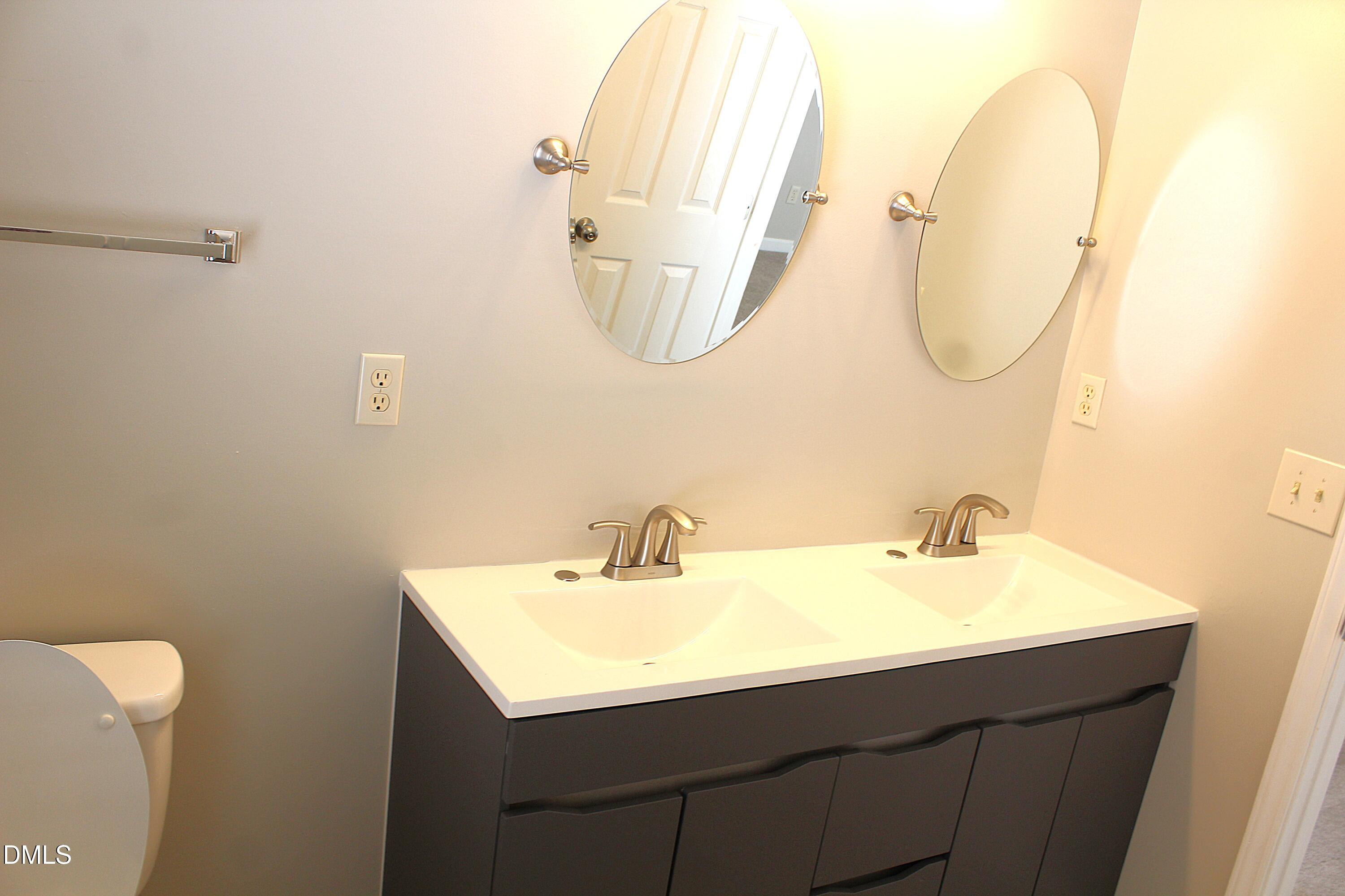 4305 Standing Rock Way Raleigh, NC 27604 - Photo 8 of 11 a bathroom with a sink vanity and a mirror
