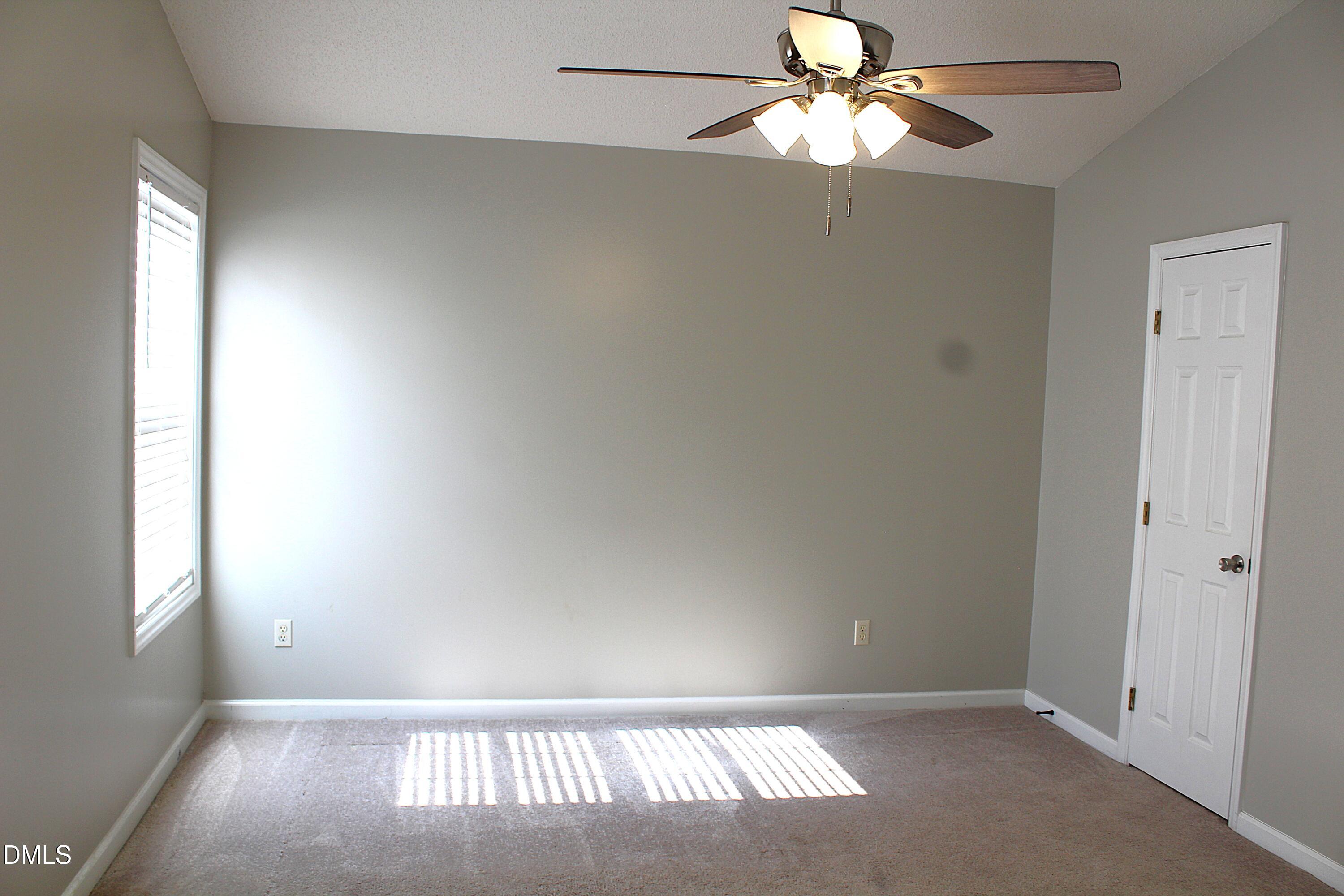 4305 Standing Rock Way Raleigh, NC 27604 - Photo 9 of 11 an empty room with windows and fan