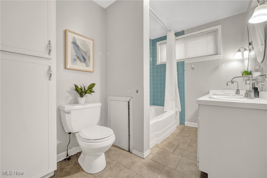 2440 White Road Cleveland, OH 44118 - Photo 24 of 43 Full bathroom featuring tile patterned floors, vanity, shower / bath combo with shower curtain, and toilet