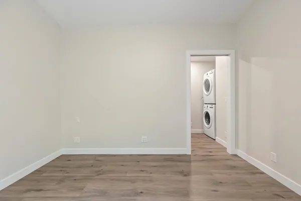 a view of a room with wooden floor and a sink
