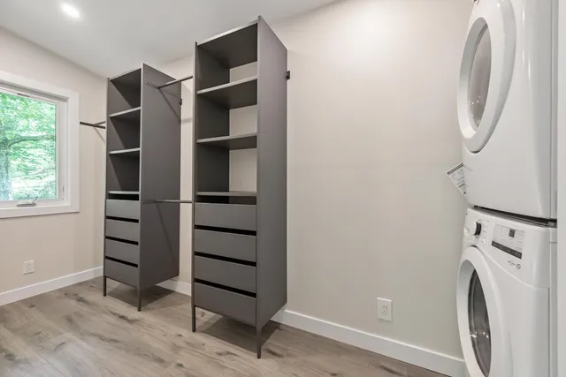 a view of walk in closet with empty racks