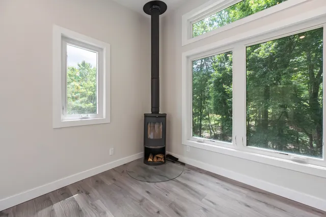 a view of a room that has a window and wooden floor
