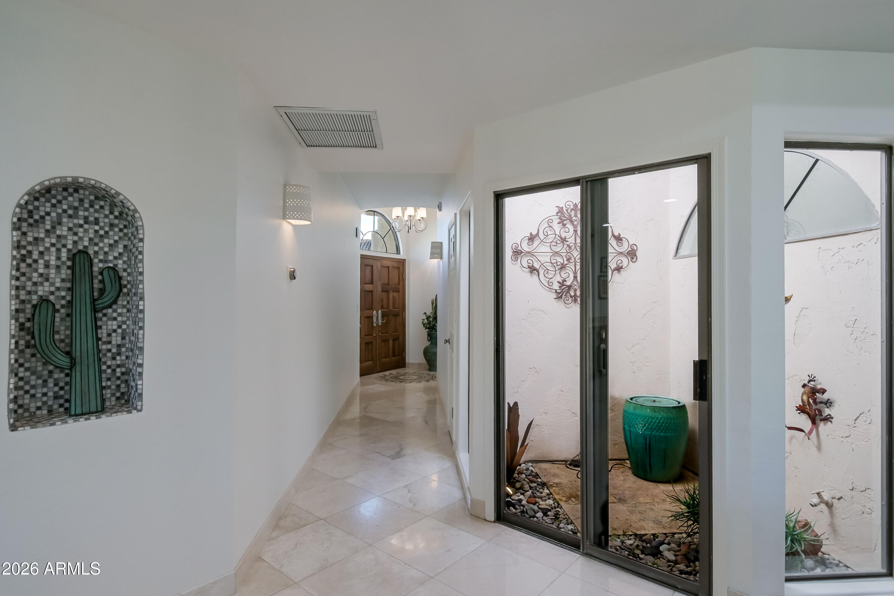 7955 East Chaparral Road, Unit 62 Scottsdale, AZ 85250 - Photo 14 of 38 a view of a hallway with windows and chandelier