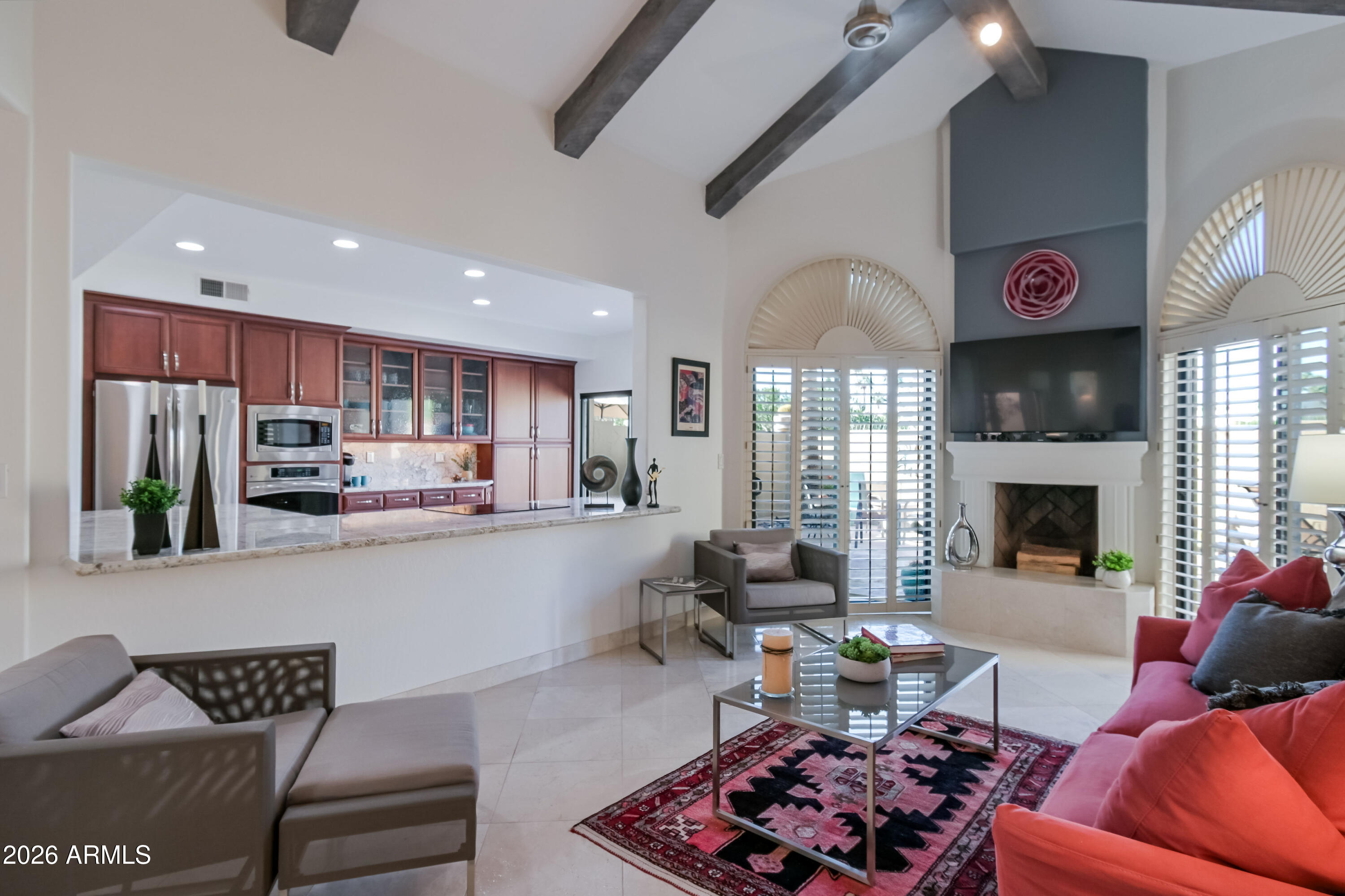 7955 East Chaparral Road, Unit 62 Scottsdale, AZ 85250 - Photo 2 of 38 a living room with stainless steel appliances kitchen island granite countertop furniture and a fireplace
