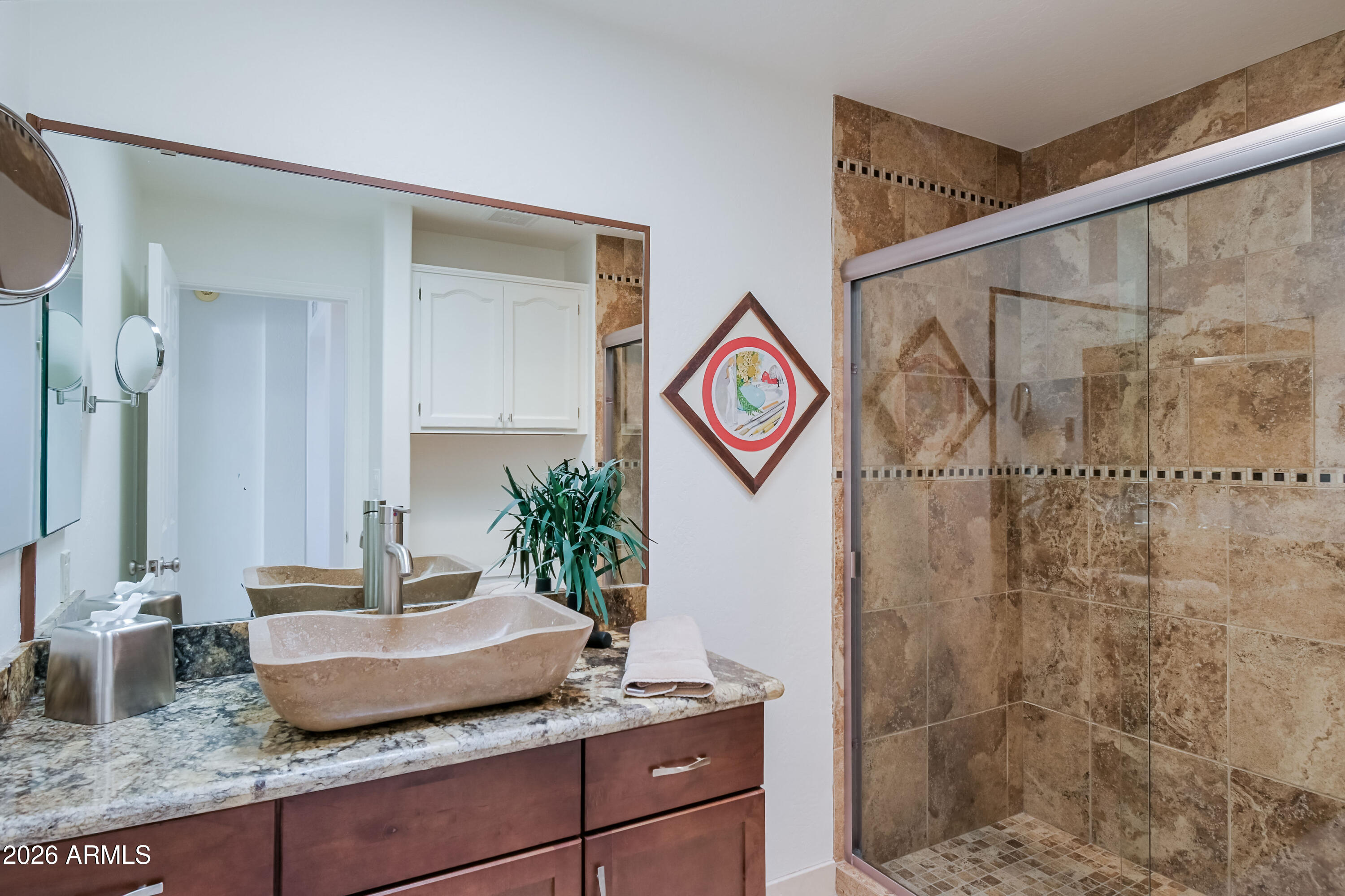 7955 East Chaparral Road, Unit 62 Scottsdale, AZ 85250 - Photo 21 of 38 a bathroom with a granite countertop sink and a mirror